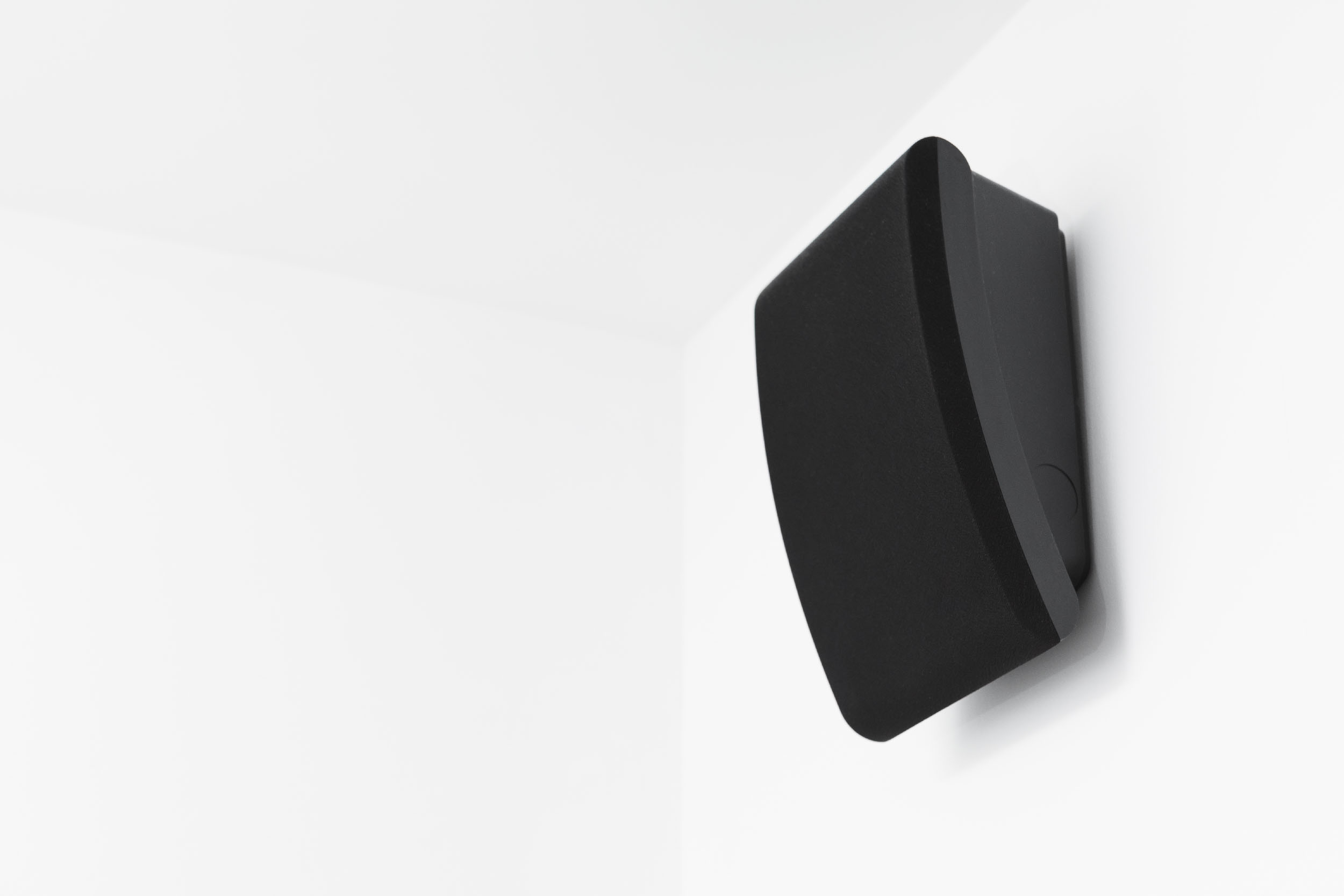 intercom speaker mounted on white wall